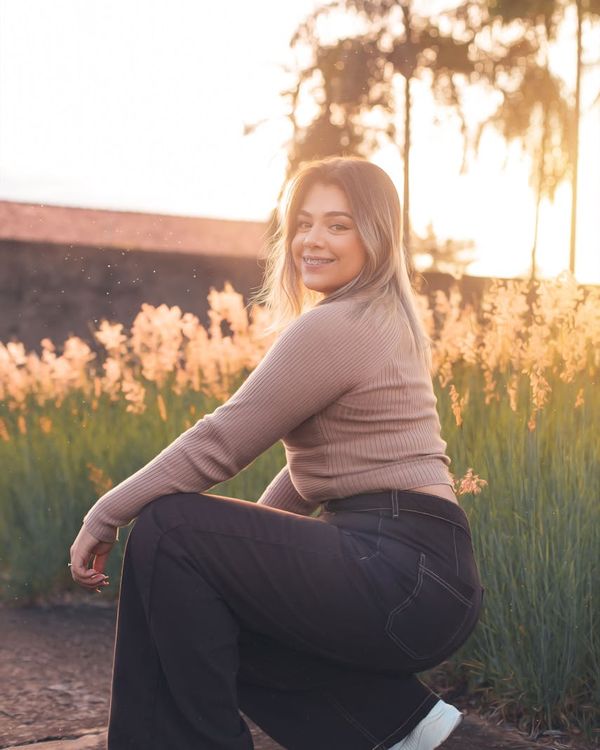 Woman performing a fluid yoga pose in a warm, serene environment.